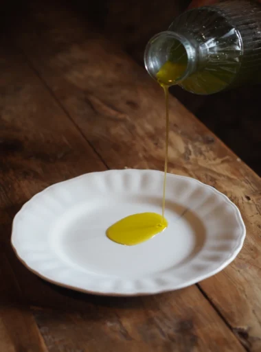 Olive Oil dripping Extra virgin olive oil served for tasting